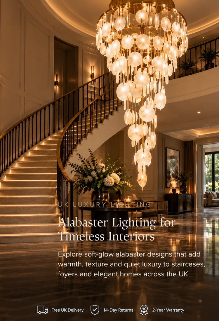 Luxury interior staircase with a large cascading alabaster crystal chandelier hanging above polished wood floors. Text overlay reads 'Alabaster Lighting for Timeless Interiors' with additional promotional copy and delivery/warranty icons at the bottom.