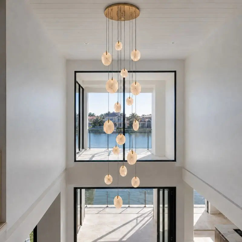 Modern Discs Long Staircase Alabaster Chandelier — shown in an interior setting 3